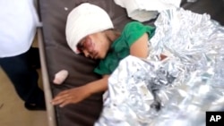 This image made from video taken Aug. 9, 2018, shows a child injured in an airstrike resting at a hospital in Saada, Yemen.